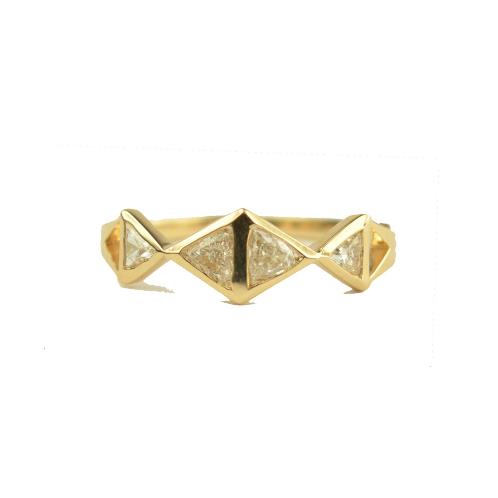 Gold ring with white trillion diamonds and geometric design on a white background